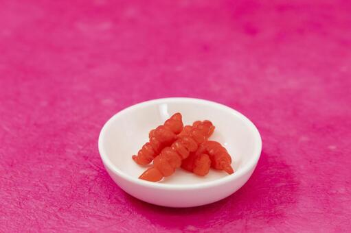 華やかなピンク背景のちょろぎ ちょろぎ,草石蚕,おせち料理の写真素材