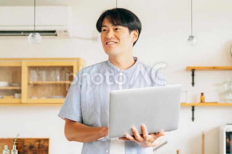 パソコンを使う男性（笑顔） テレワーク,在宅勤務,パソコンの写真素材