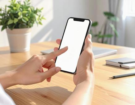 白画面のスマホを持つモックアップ写真 白画面のスマホを持つモックアップ写真の写真