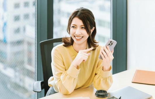 スマホを使う笑顔の女性・ビジネスウーマン スマホを使う笑顔の女性・ビジネスウーマン 女性,スマホ,スマートフォンの写真素材