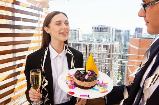 ケーキを持つ男性と話す女性 男女,女性,外国人の写真素材