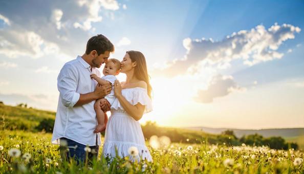 青空と草原と家族（ファミリー）赤ちゃんの写真