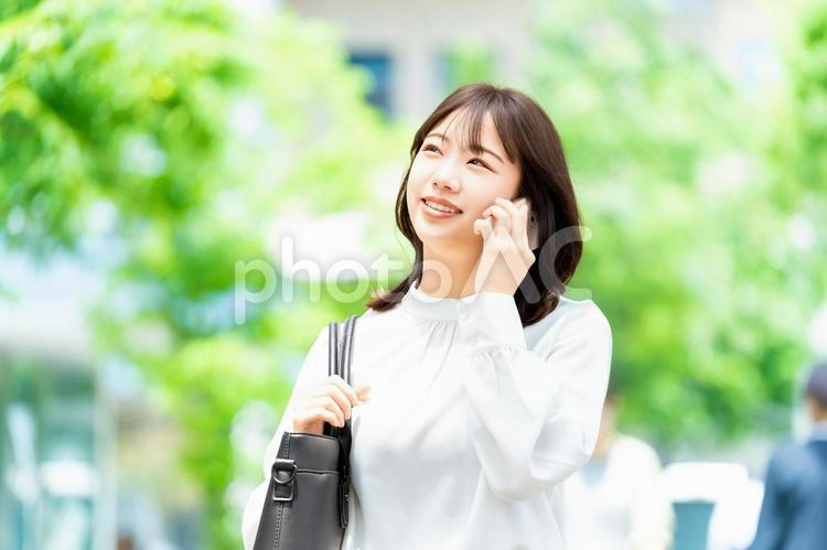 スマホで話す笑顔の女性・ビジネスウーマン 女性,スマホ,夏の写真素材