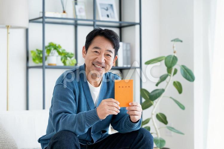 年金手帳を持つミドルの男性 年金,年金手帳,男性の写真素材