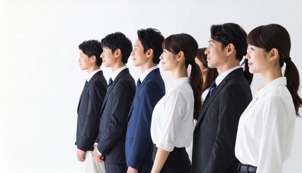 斜めの角度から見た整列する若い会社員 斜めの角度から見た整列する若い会社員の写真
