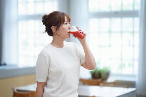 トマトジュースを飲む女性の横顔 女性,トマトジュース,赤の写真素材
