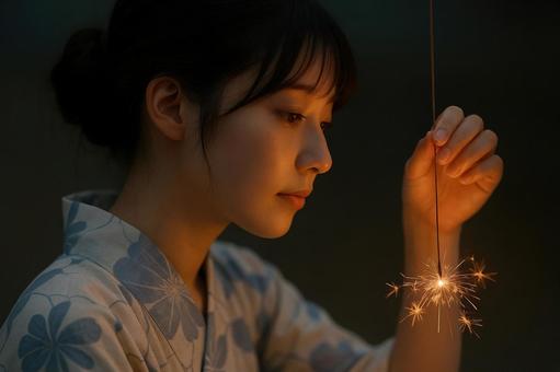 線香花火を持つ日本人の若者 線香花火を持つ日本人の若者の写真
