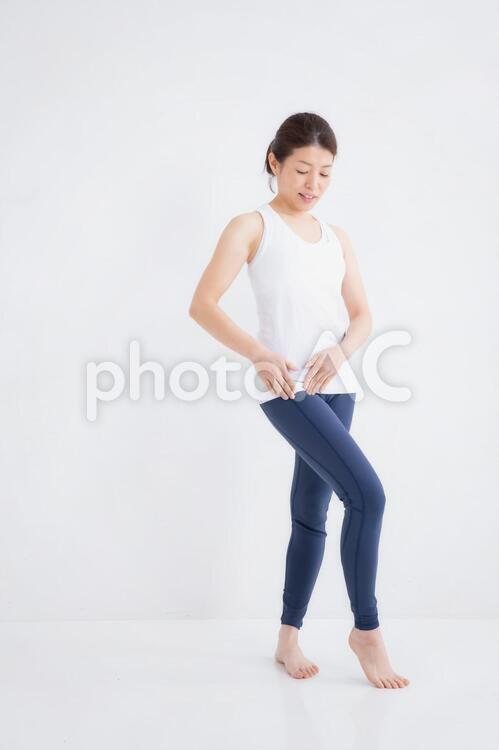 スポーツウェアをきた女性 股関節,坐骨神経痛,付け根の写真素材