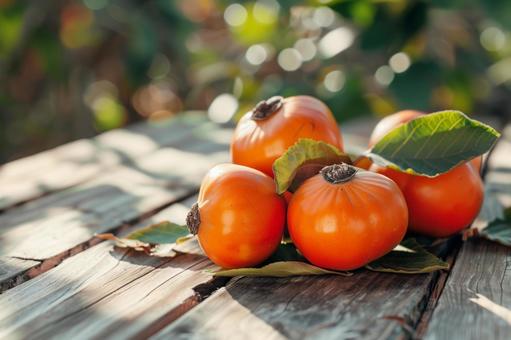 テーブルに並んだ熟れた柿の写真