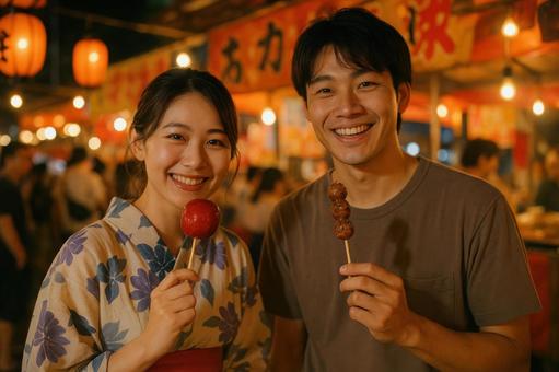 屋台でグルメを楽しむカップル 屋台でグルメを楽しむカップルの写真