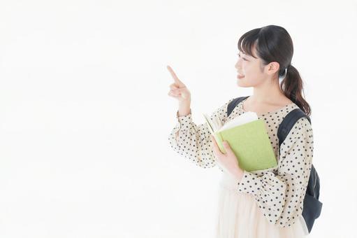 上を指差す制服を着た女子学生 上を指差す制服を着た女子学生 発見,目的地,案内の写真素材