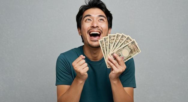 大金を手にして喜ぶ男性 大金を手にして喜ぶ男性の写真