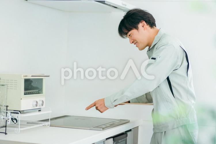 キッチンと作業着姿の男性（IH） ih調理器,ih,ihクッキングヒーターの写真素材