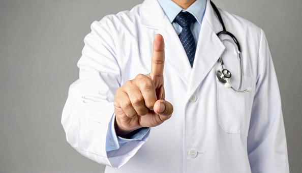 注意! 人差し指を立てる白衣を着た男性 注意! 人差し指を立てる白衣を着た男性の写真