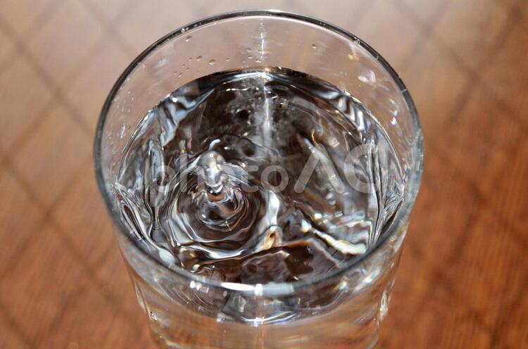 コップに入った水に水滴を落としたところ3 ガラス,グラス,テーブルの写真素材