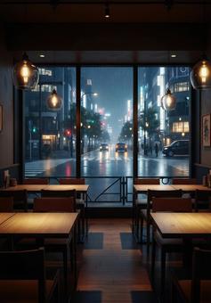 都会のカフェから雨の夜景を眺める風景の写真