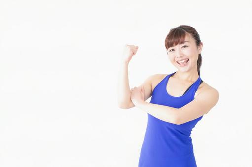 筋肉を鍛えるスポーツウェアを着た女性 筋肉を鍛えるスポーツウェアを着た女性 パーソナルトレーナー,若い,ウエイトの写真素材