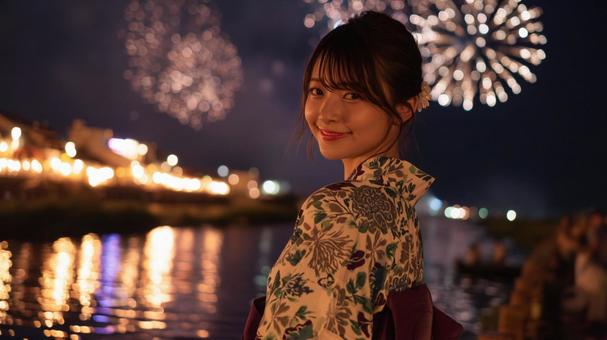 打ち上げ花火を背景に笑顔の浴衣女性 打ち上げ花火を背景に笑顔の浴衣女性の写真