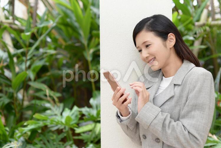 スマートフォンを持つ笑顔の女性 女性,スマートフォン,女の写真素材