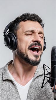 マイクに向かって歌う男性の写真