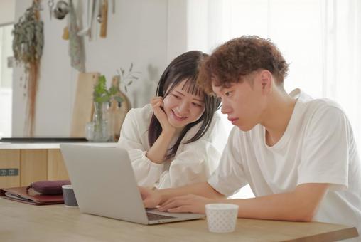 パソコンを見ながらお金の管理を行う夫婦 パソコンを見ながらお金の管理を行う夫婦 家計管理,貯金,節約の写真素材