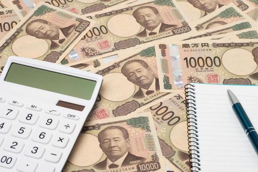 一万円札上に置かれた電卓とノートとペン 一万円札上に置かれた電卓とノートとペン お金,紙幣,現金の写真素材