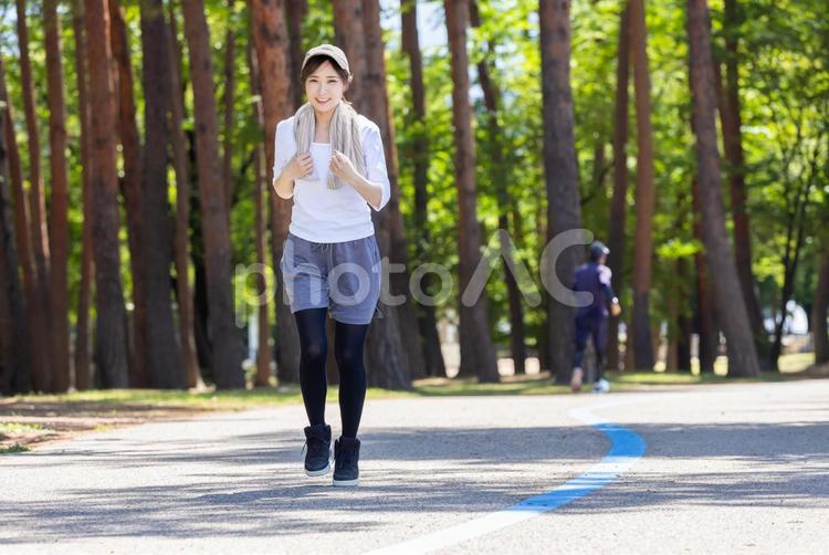 公園をランニングする女性 女性,ランニング,走るの写真素材