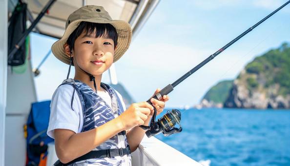 釣りを楽しむ男の子 釣りを楽しむ男の子の写真