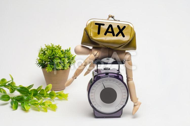 重たい税金に潰されたデッサン人形 tax,税金,社会保険料の写真素材
