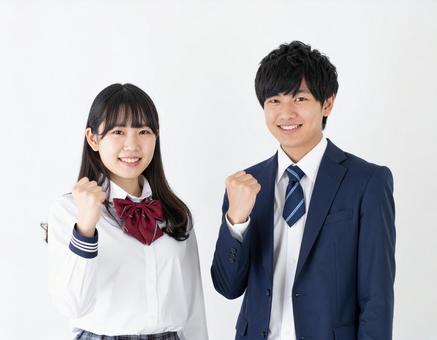 ガッツポーズする高校生男女 ガッツポーズする高校生男女の写真
