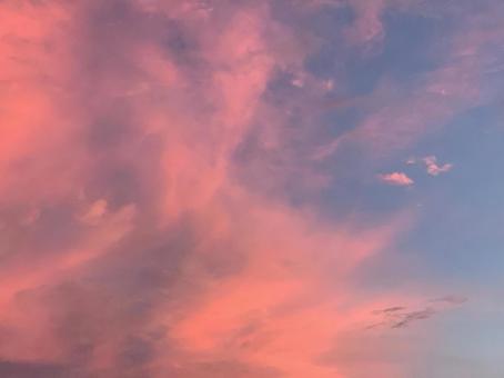 ピンクに染まる雲と水色の空の写真