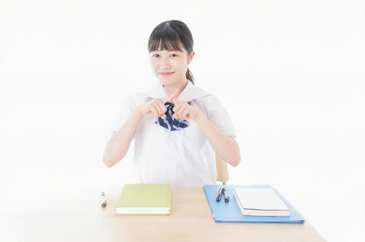 バツを示す制服姿の女子学生 バツを示す制服姿の女子学生 中学生,禁止,いじめの写真素材