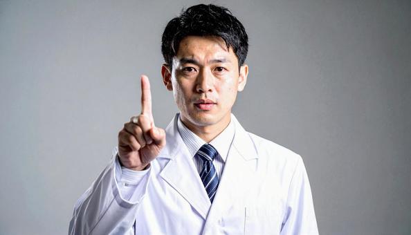 注意! 人差し指を立てる白衣を着た男性 注意! 人差し指を立てる白衣を着た男性の写真