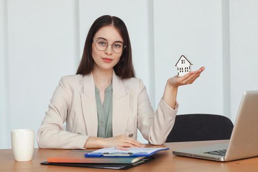家の模型を手に持つ女性 保険業,事務職,接客業の写真素材