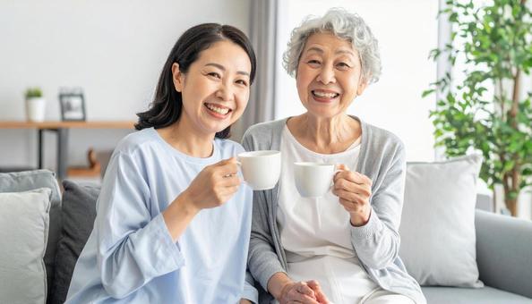 お茶を飲むシニアとミドル女性 お茶を飲むシニアとミドル女性の写真