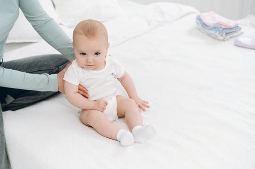 Baby sitting in white baby socks, JPG Baby sitting in white baby socks, JPG