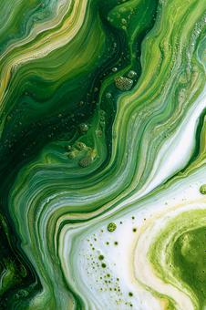 緑と白の混ざり合う液体テクスチャの写真
