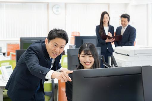オフィスで仕事をする男女のビジネスマン オフィスで仕事をする男女のビジネスマンの写真