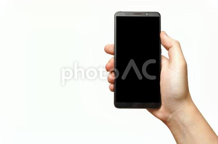 スマホを操作する男性の片手-白背景 スマホ,スマートフォン,手の写真素材