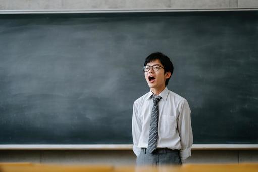 黒板の前で発表する男子生徒のイメージ 黒板の前で発表する男子生徒のイメージの写真