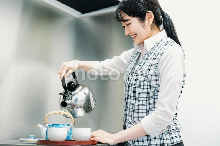 お茶をいれる会社員の女性 給湯室,お茶淹れ,お茶くみの写真素材
