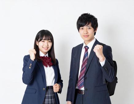 ガッツポーズする高校生男女 ガッツポーズする高校生男女の写真