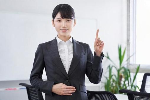 Japanese female business woman giving an explanation by pointing at the office, female, finger pointing, point, JPG