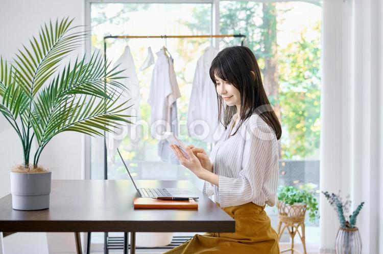 計算機を使う女性　家計簿　リモートワーク ビジネスウーマン,女性,主婦の写真素材