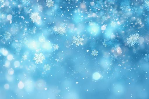 青い背景に舞う雪の結晶と幻想的な光 青い背景に舞う雪の結晶と幻想的な光の写真