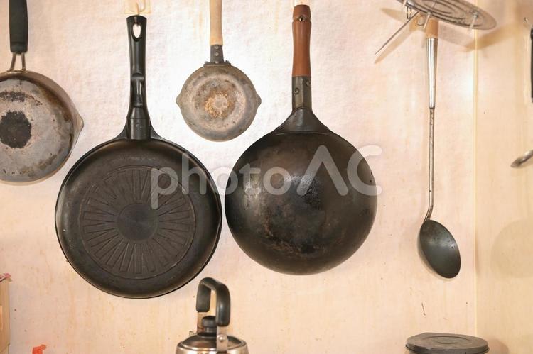 汚れたキッチンの壁面に吊るされた調理器具 キッチン,台所,壁面の写真素材