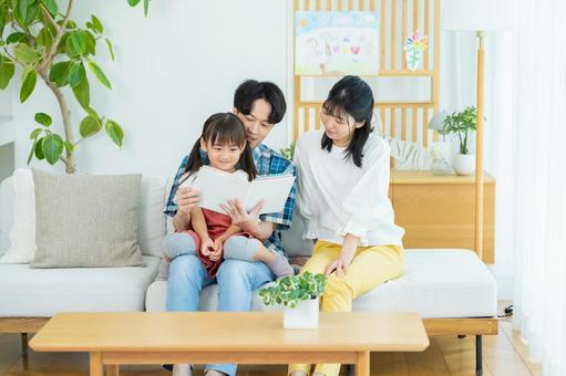 リビングで遊ぶ家族 リビングで遊ぶ家族 家族,笑顔,読み聞かせの写真素材