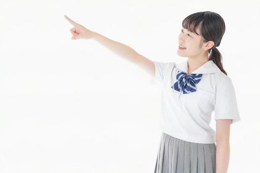 上を指差す制服を着た女子学生 進路,案内,女性の写真素材