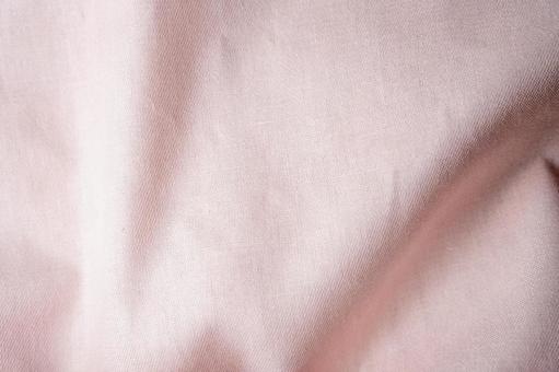 ピンク布のしわテクスチャ背景 布,生地,布地の写真素材