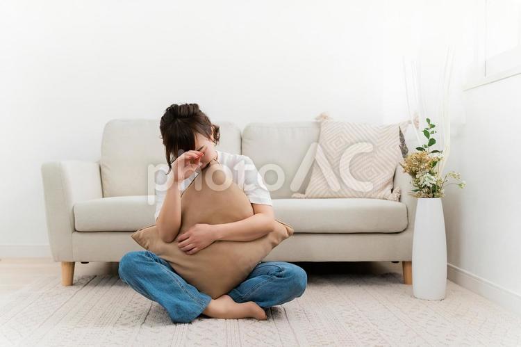 家で考え事をして悩むアジア人女性 悩む,体調不良,うつ病の写真素材